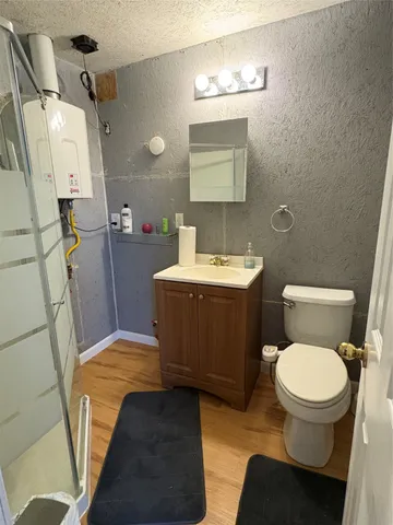 a kitchen with kitchen island granite countertop wooden cabinets a refrigerator and a sink