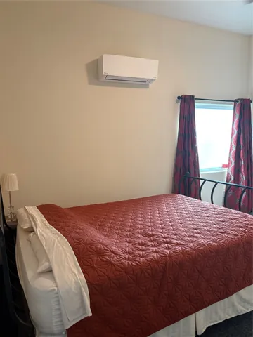 a bedroom with a bed and cabinets