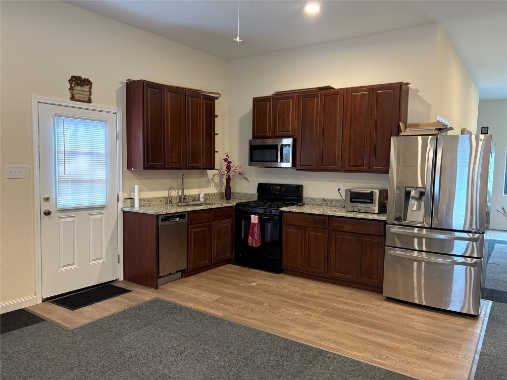 12151 State Highway 75 North Buffalo, TX 75831 - Photo 24 of 50 Conveniently located to the left upon entry, this modern kitchen features sleek appliances and rich wooden cabinetry.