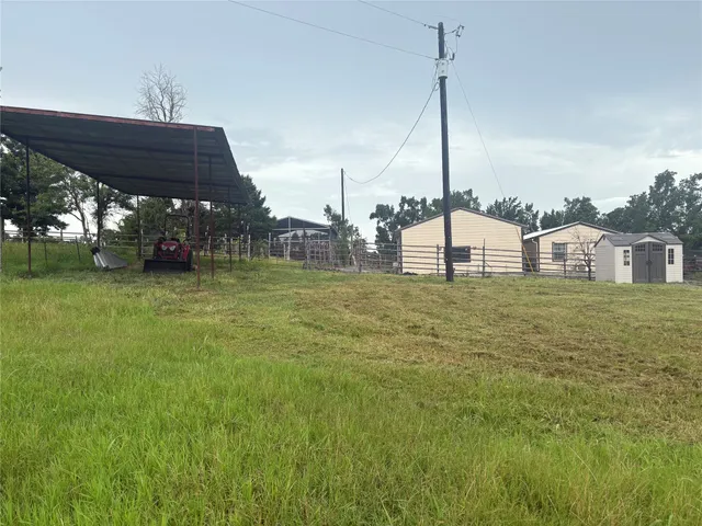 a view of a house with a yard and wooden fence