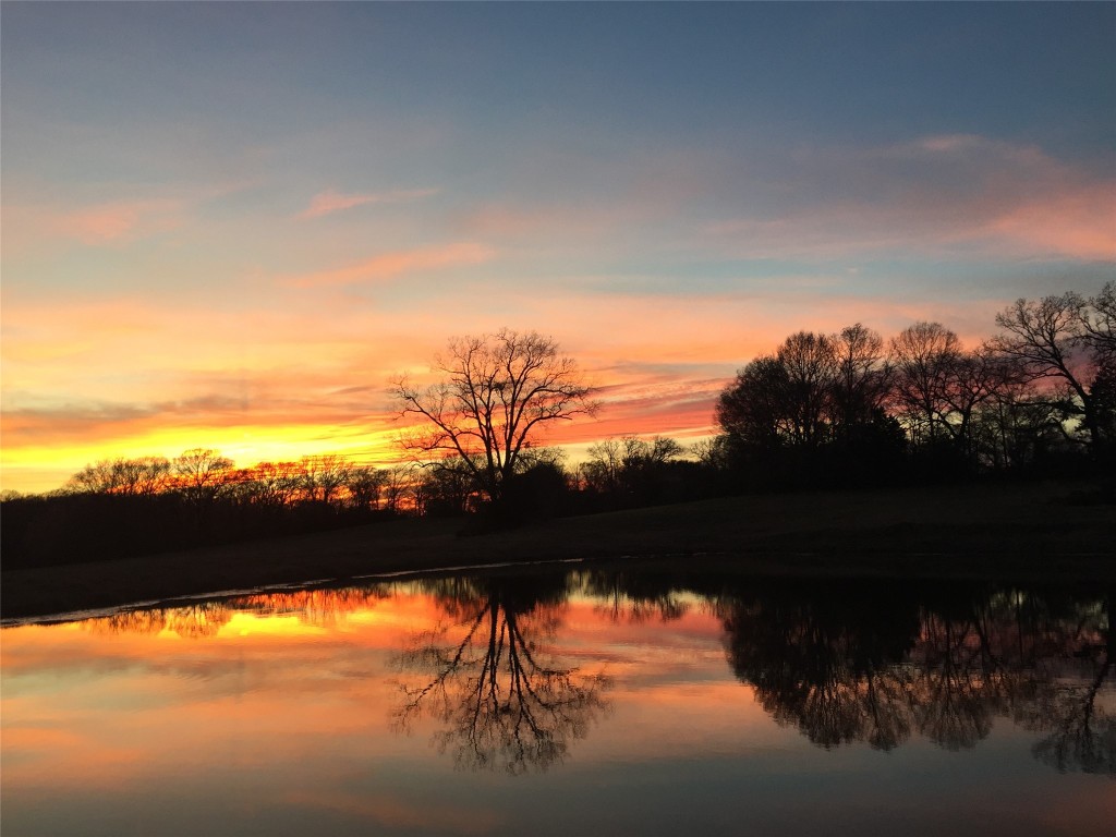 12151 State Highway 75 North Buffalo, TX 75831 - Photo 50 of 50 Idyllic sunset view over the pond can be observed from the porch to help you unwind and relax at the end of your day.