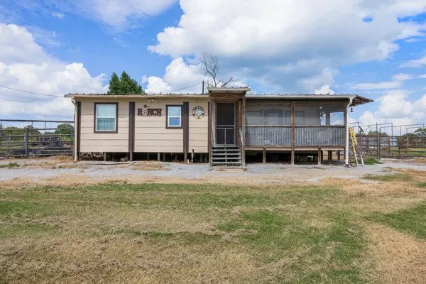 a view of a house with a yard and sitting area
