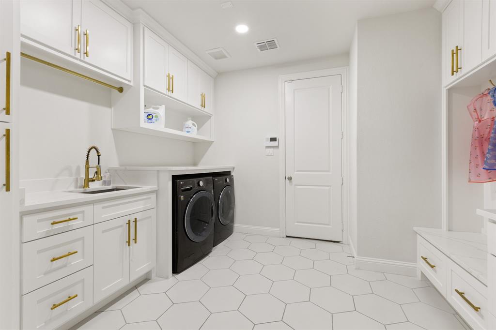 2116 Randas Way Rockwall, TX 75087 - Photo 16 of 40 a utility room with cabinets washer and dryer