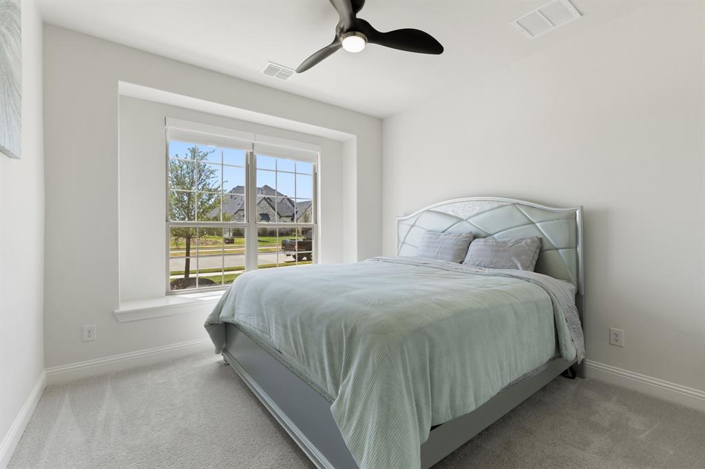 2116 Randas Way Rockwall, TX 75087 - Photo 19 of 40 a bedroom with a large bed and a window