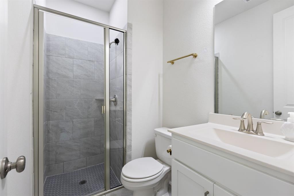 2116 Randas Way Rockwall, TX 75087 - Photo 20 of 40 a bathroom with a sink a toilet and shower