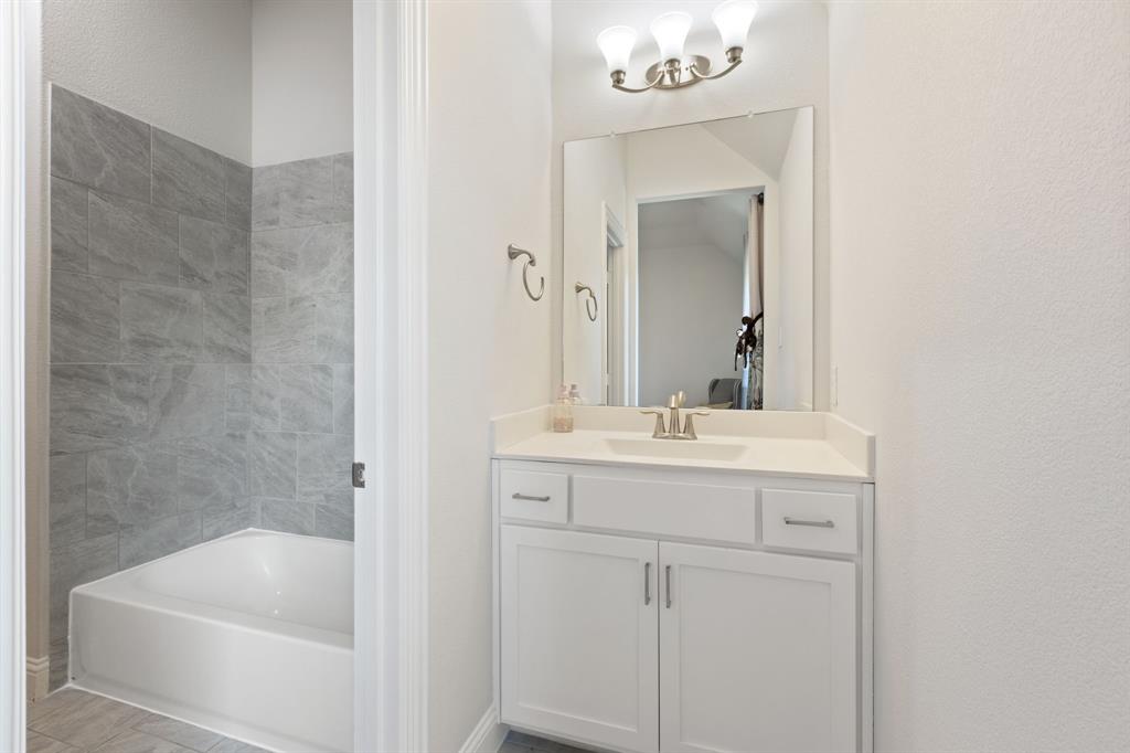 2116 Randas Way Rockwall, TX 75087 - Photo 28 of 40 a bathroom with a sink a mirror and a bathtub