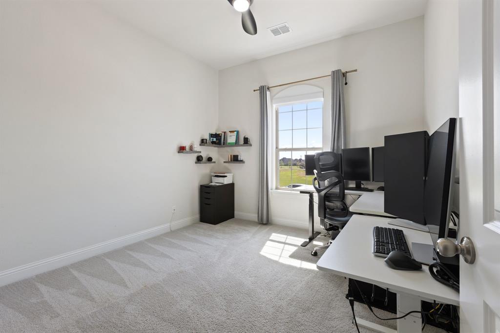 2116 Randas Way Rockwall, TX 75087 - Photo 29 of 40 a view of workspace with windows cabinet and flat screen tv