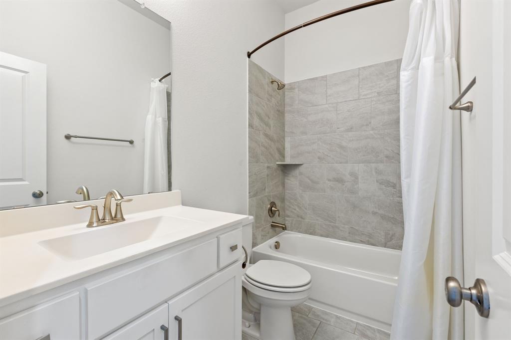 2116 Randas Way Rockwall, TX 75087 - Photo 31 of 40 a bathroom with a sink a toilet and shower