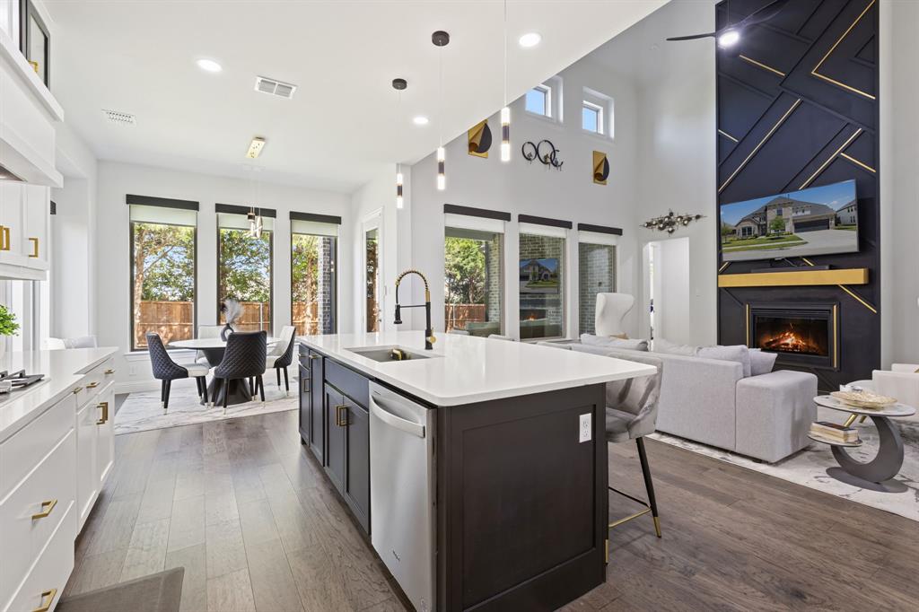 2116 Randas Way Rockwall, TX 75087 - Photo 4 of 40 an open kitchen with a table and chairs