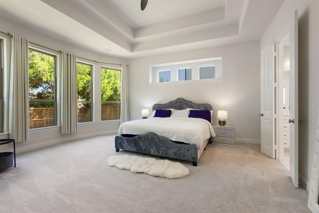 2116 Randas Way Rockwall, TX 75087 - Photo 10 of 40 a bedroom with a large bed and a large window
