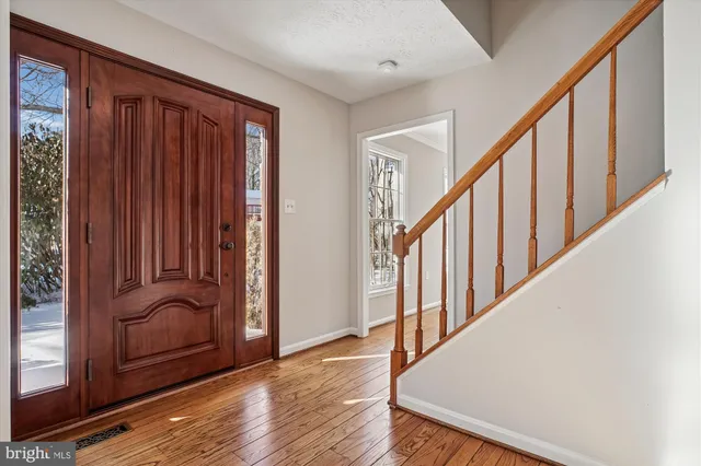 a view of an entryway with wooden floor and stairs