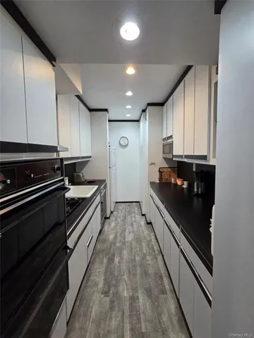 a large kitchen with stainless steel appliances granite countertop a stove and a refrigerator