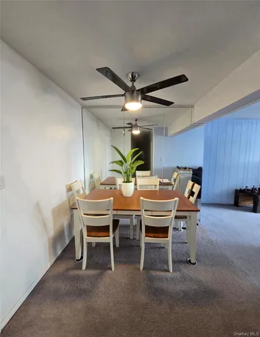 a dining room with furniture and a potted plant