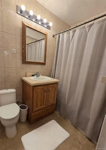a bathroom with a toilet a sink and a mirror