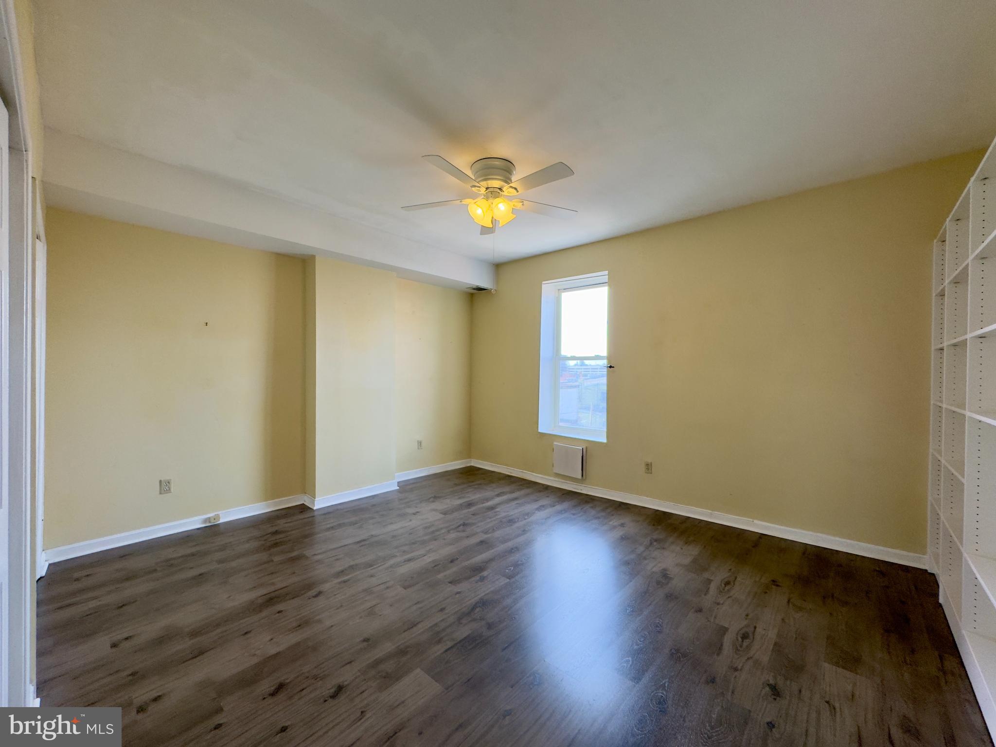 1812 North Calvert Street Baltimore, MD 21202 - Photo 12 of 24 a view of an empty room with wooden floor and a window