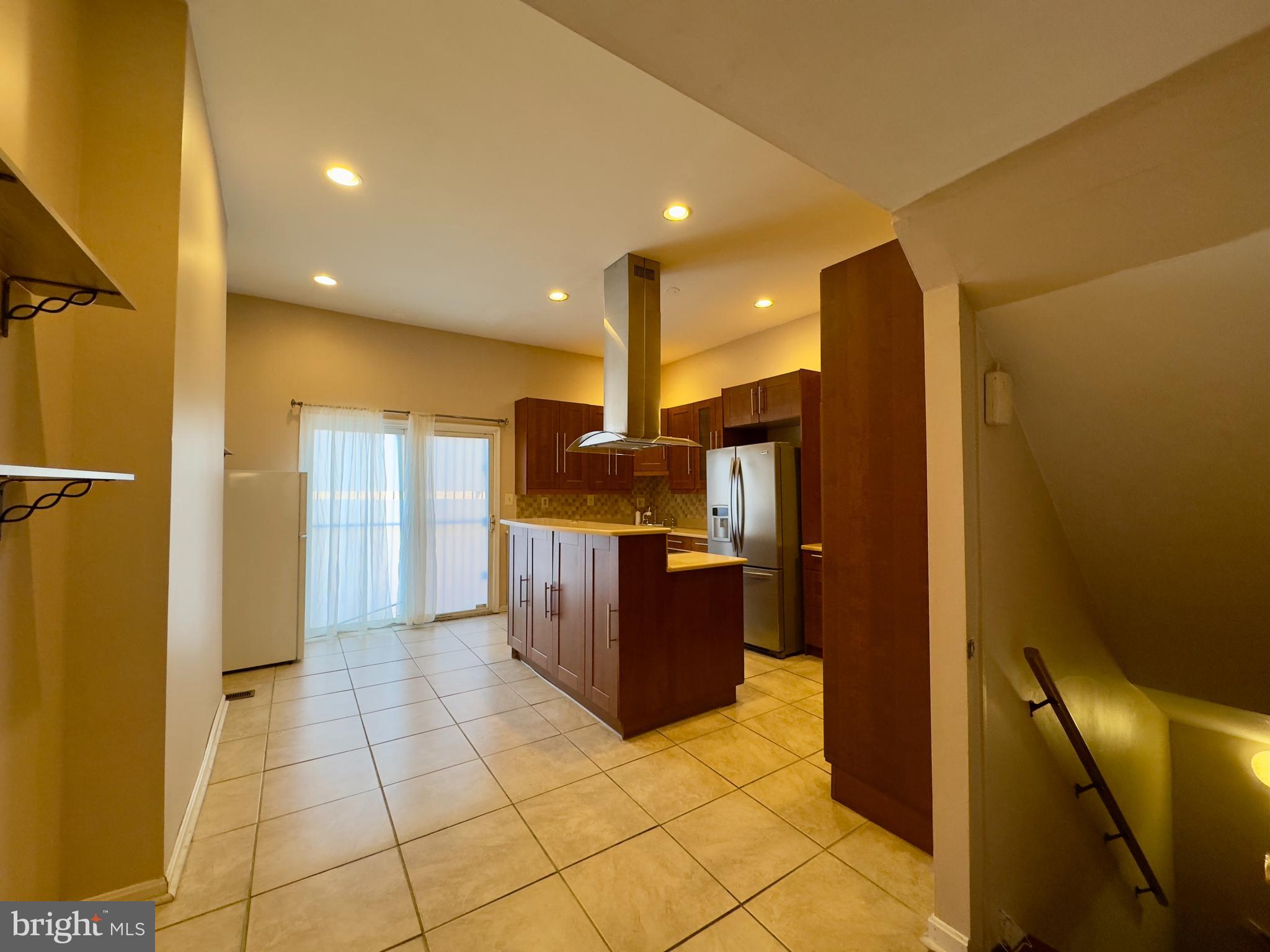 1812 North Calvert Street Baltimore, MD 21202 - Photo 15 of 24 a kitchen with stainless steel appliances granite countertop a refrigerator and a wooden cabinets