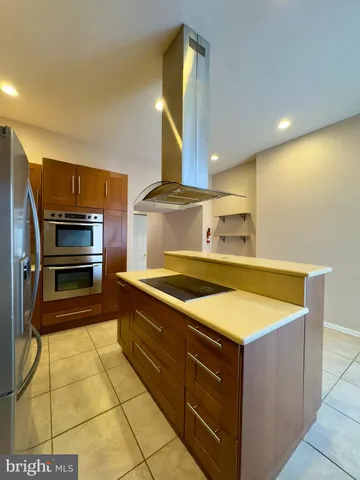 a kitchen with stainless steel appliances granite countertop a sink and a stove