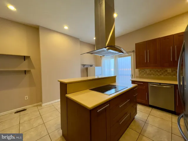 a kitchen with a stove and a refrigerator