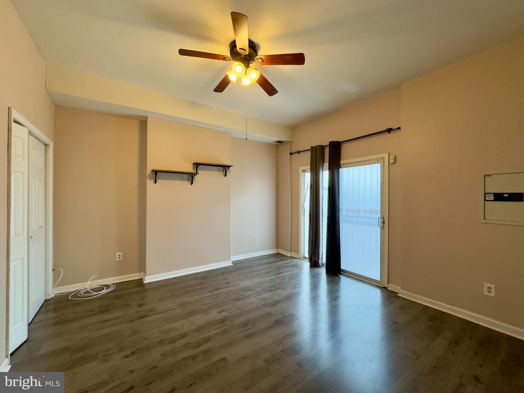 1812 North Calvert Street Baltimore, MD 21202 - Photo 7 of 24 an empty room with wooden floor fan and windows