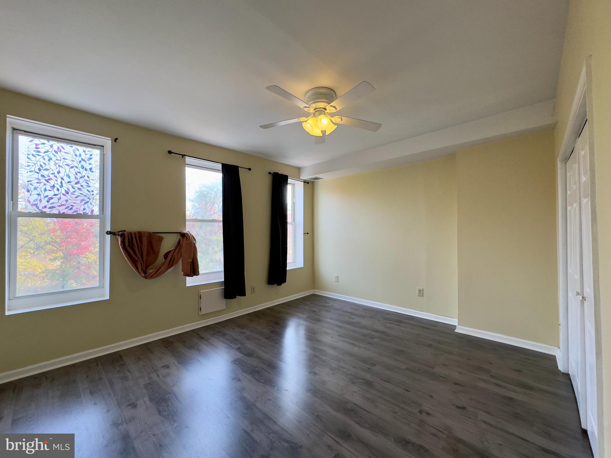 1812 North Calvert Street Baltimore, MD 21202 - Photo 10 of 24 a view of an empty room with window and wooden floor
