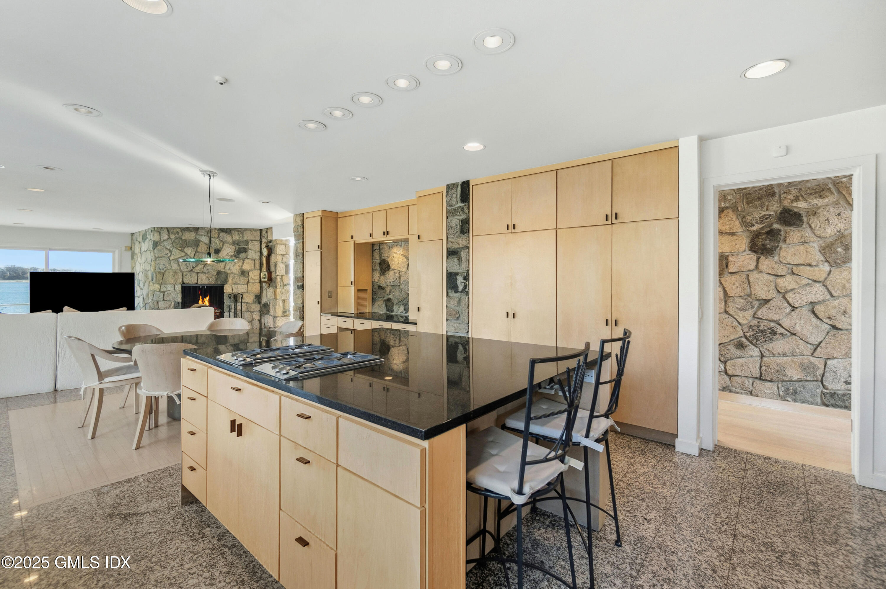 111 Byram Shore Road Greenwich, CT 06830 - Photo 10 of 23 a kitchen with stainless steel appliances granite countertop a table chairs sink and cabinets