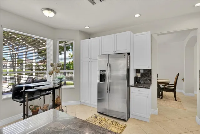 a kitchen with a stove a refrigerator and cabinets