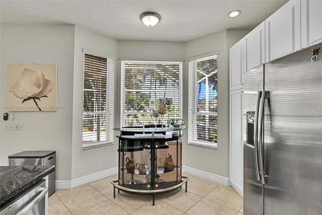 a living room with furniture a flat screen tv and a large window