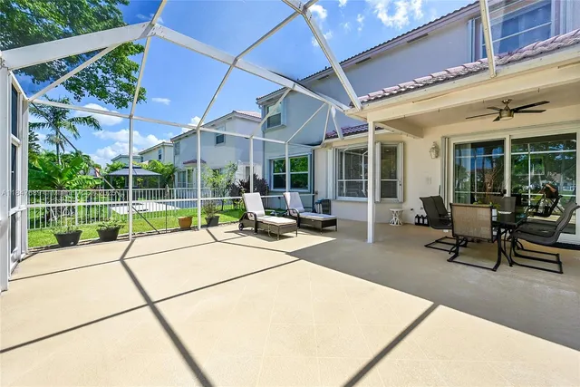 a view of a house with backyard and porch