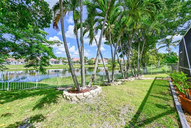 an aerial view of residential houses with outdoor space and lake view