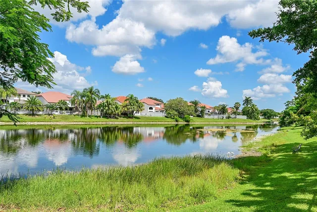 an aerial view of residential houses with outdoor space and river