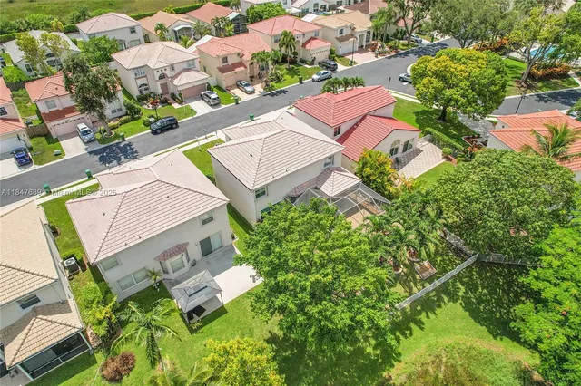 an aerial view of a house with a yard and garden