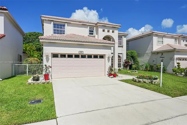 a front view of a house with a yard and garage