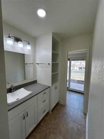 a bathroom with a granite countertop sink and a mirror