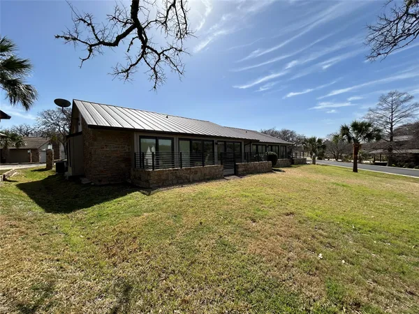 a view of a house with backyard and sitting area