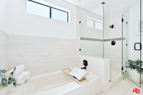 a bath room with a bath tub and shower