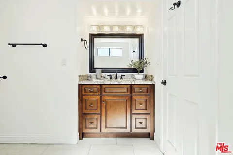 a bathroom with a stove and a mirror