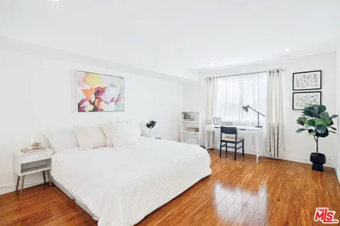 a bed room with a bed and a chair