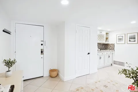 a view of kitchen with furniture and refrigerator
