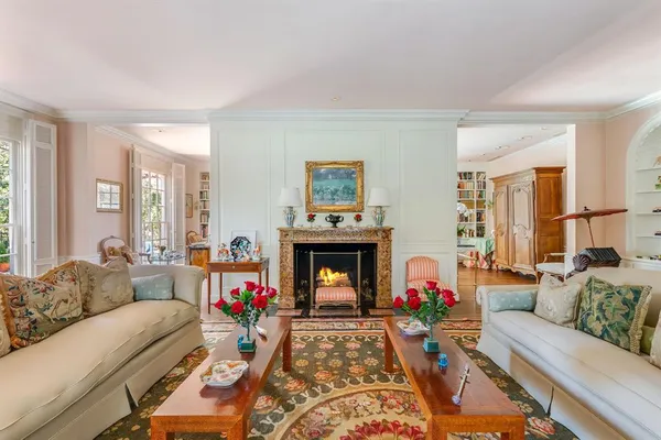 a living room with furniture fireplace and window