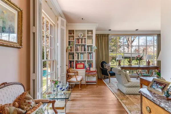 a living room with furniture and a floor to ceiling window