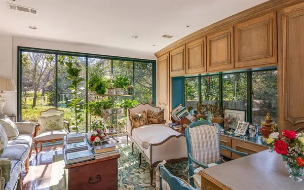 a living room with furniture and floor to ceiling windows