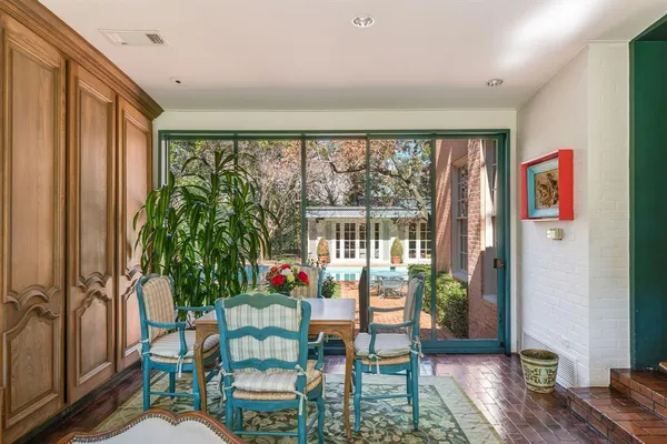 a living room filled with furniture and a potted plant