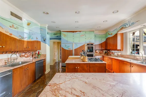 a large kitchen with stainless steel appliances kitchen island granite countertop a sink and counter space