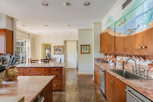 a large kitchen with kitchen island granite countertop a sink and cabinets
