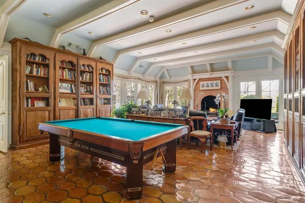 a room with pool table and furniture