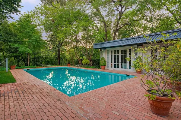 a view of an house with swimming pool and porch