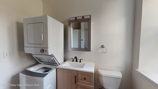 a bathroom with a toilet sink and mirror