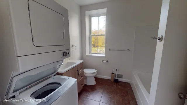a bathroom with a toilet a sink and bath tub