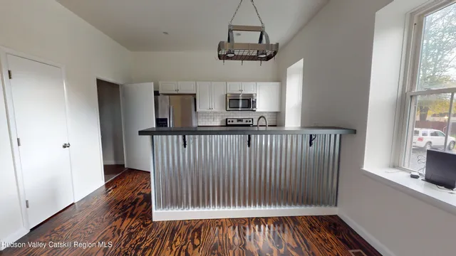 a view of a kitchen from a hallway