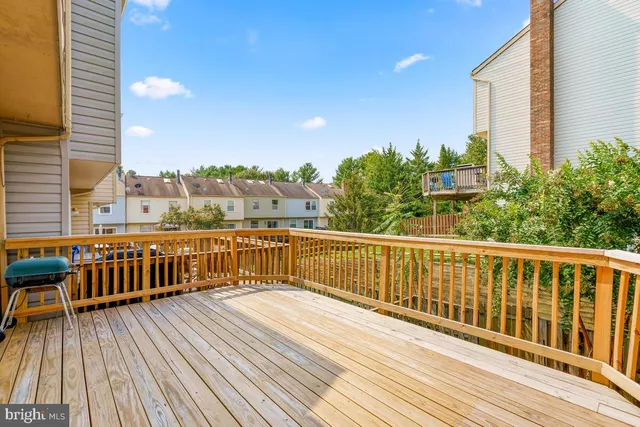 a view of balcony with wooden floor and fence